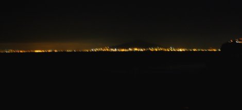 Naples by night with Vesuvius looming